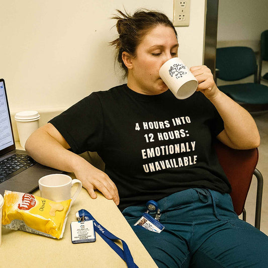 Funny ER nurse gift — cotton nurse t-shirt reading "Emotionally unavailable. Clinically, rom"